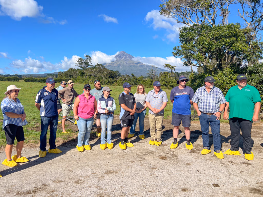 The tour group on Graham Robinson’s farm with the backdrop of stunning Mount Taranaki